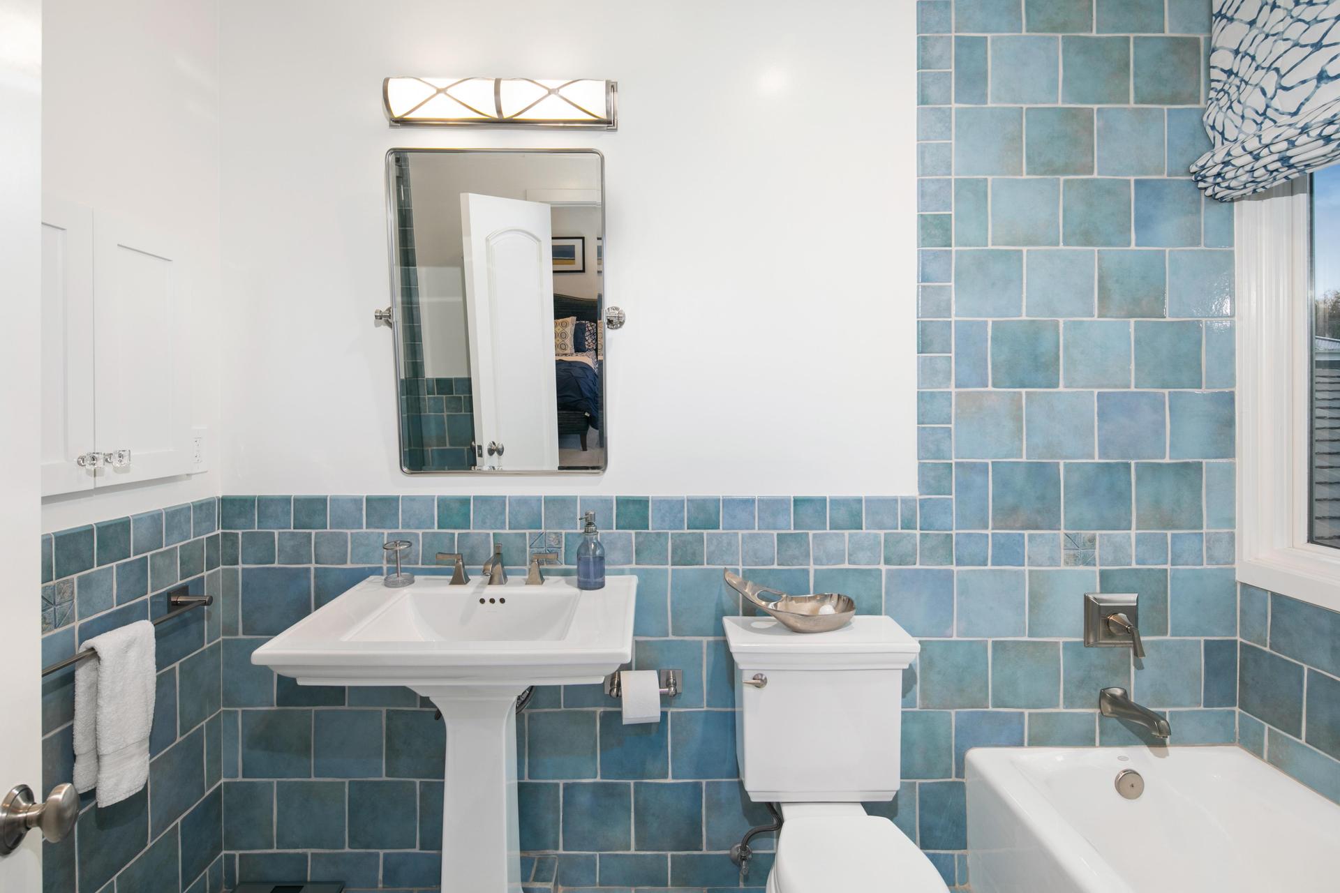 Bathroom with blue tile and soaking tub
